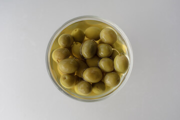 Bowls with marinated olives top view. Mediterranean snack or appetizer.