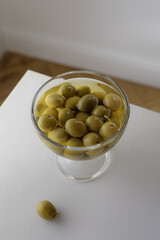 Bowls with marinated olives on stone table top view. Mediterranean snack or appetizer.