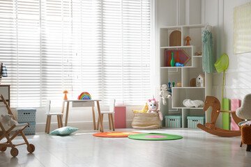 Stylish playroom with toys and furniture. Interior design