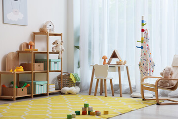 Stylish playroom with toys and furniture. Interior design