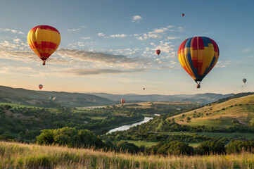 Obraz premium Colorful hot air balloons drift over rolling hills at sunrise clouds landscape