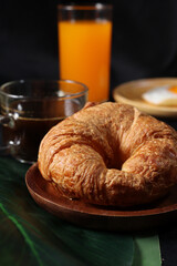 Breakfast of coffee cup egg  orange juice and croissant