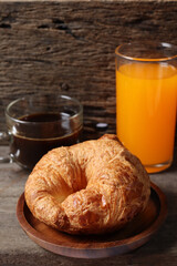 Breakfast of coffee cup orange juice and croissant