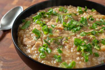A view of a bowl of arroz caldo.