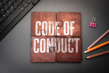 Code of Conduct Concept Shown on Puzzle Pieces in Office Workspace Setting