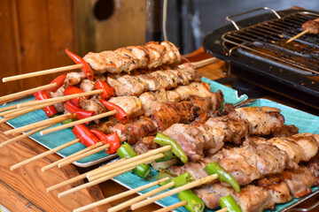 Grilled pork shashlik kebabs on barbecue outdoors at back yard. Meat lamb kebab on BBQ. Barbecue shish kebab at outdoor picnic top view, selective focus, series.