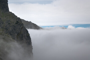Clouds over the valley, a journey along a trail in the high mountains.
