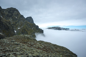 Mountain peaks above the clouds. Landscape of the High Tatras.
