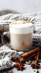 Hot chai latte with cinnamon, star anise and cardamom in glass mug