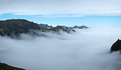 Mountain peaks above the clouds. Landscape of the High Tatras.
