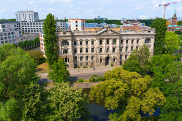Fototapeta premium Historic Building Surrounded By Lush Greenery And Urban Landscape in Berlin, Germany