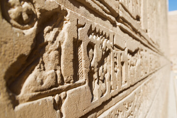 Isolated close up of hieroglyphics carved in sandstone at the temple of Edfu, Egypt, dedicated to...