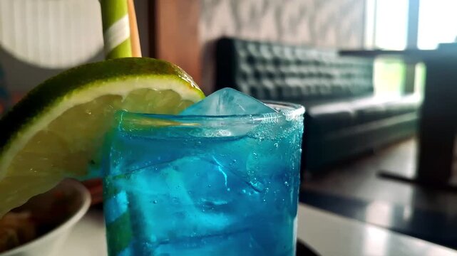 Refreshing Blue Lagoon drink with vibrant blue color, lemony citrus flavor, vodka, and lemonade&mdash;perfect for summer parties and relaxation