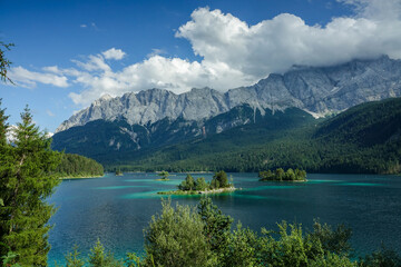 Idyllic alpine lake Eibsee with Zugspitze in the background during a sunny summer day in Germany