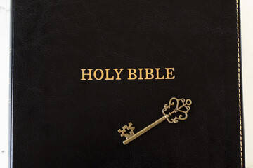 Christian holy bible book with antique key. Top view. Biblical prophecy, wisdom, revelation from...