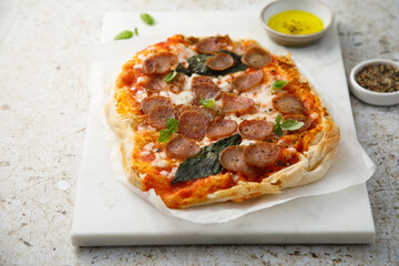 Pepperoni pizza with fresh basil
