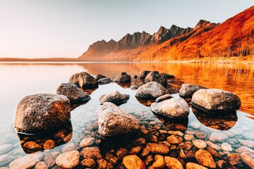 Tranquil lake reflecting autumnal mountains
