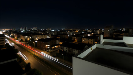 Building Long-exposure rooftop scene capturing light trails from passing cars below