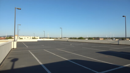 Building Photo from rooftop parking lot, showing angles, shadows, and distant towers
