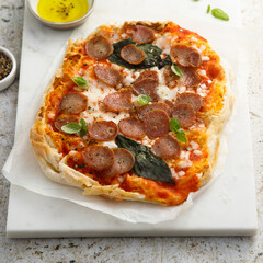 Pepperoni pizza with fresh basil