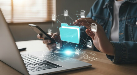 Person using smartphone and laptop with digital data transfer visualization