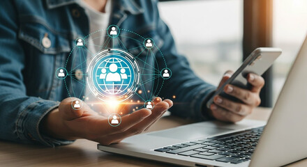 Person holding a glowing network of people connections over a laptop