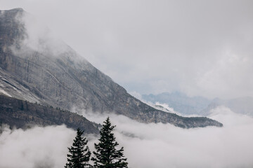 Alpine Ridge Rising Above Oeschinensee’s Scenic Valley, Rugged Snowy Peaks Tower Above Verdant Alpine Forest