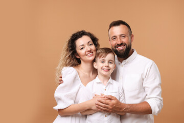 Portrait of happy family on beige background