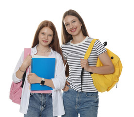Teenage girls with backpacks and notebooks on white background