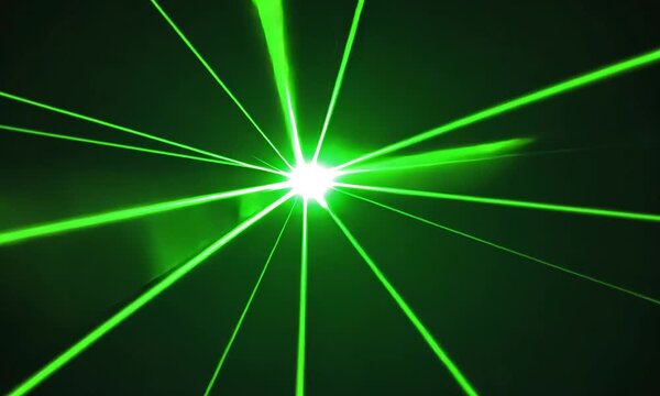 Bright green laser beams radiating outward from a central point on a black background