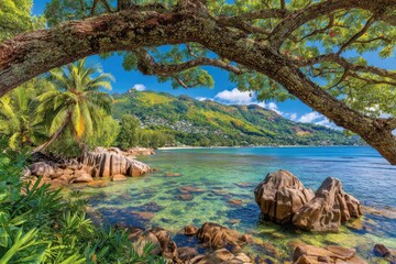 Fototapeta premium Tropical beach scene under a shady tree. Tranquil turquoise water laps gently against granite rocks. Lush greenery and mountains beyond