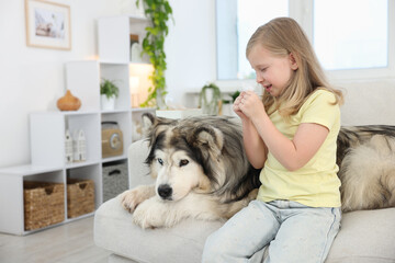 Girl suffering from allergy with her dog at home