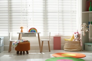 Stylish playroom with toys and furniture. Interior design