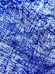 A numbered botanical label attached to the bright green leaves of a tropical tree. Scientific research and plant identification.