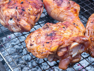 Chicken legs grilling on barbecue grill