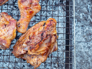 Chef grilling chicken legs on barbecue grill