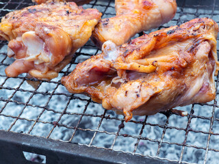Chicken pieces grilling on barbecue grill
