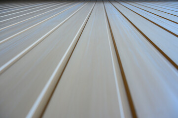 Converging lines creating a vanishing point on a white corrugated surface