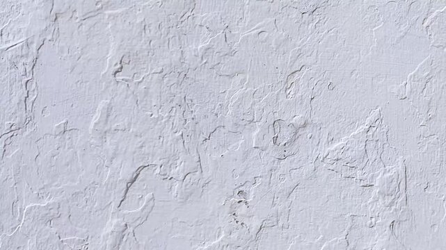 Close up textured white plaster wall, can be used as background for design projects or as a textural element in artworks.