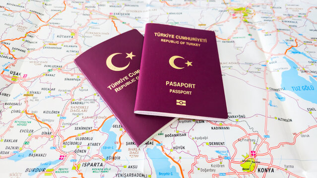 Photo series of Republic of Turkey passports in Turkish text"T&uuml;rkiye Cumhuriyeti Pasaport" on the white background and Turkey`s road map in Turkish language 

