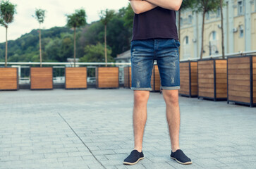 Young man in denim jeans shorts.