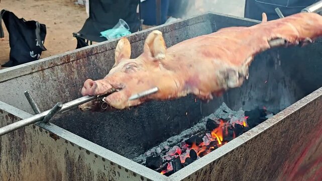 Roasted suckling pig on the spit.