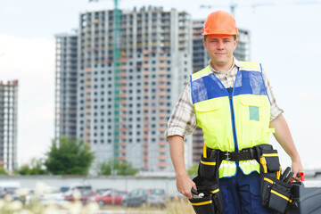 Portrait man construction worker. Male engineer construction. Contractor at a building site. Male construction worker at a building site. Business construction. Place for advertisement message.