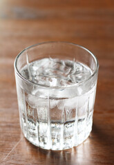 Cold water in a glass on a wooden table