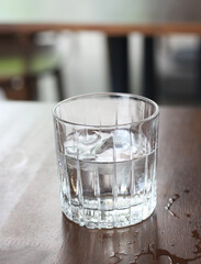 Cold water in a glass on a wooden table