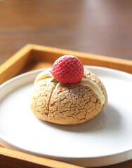 choux cream cake with strawberries on plate
