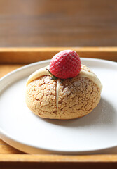 choux cream cake with strawberries on plate