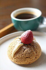 choux cream cake with strawberries on plate