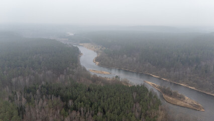 Aerial View of River and Forest Under Foggy Sky