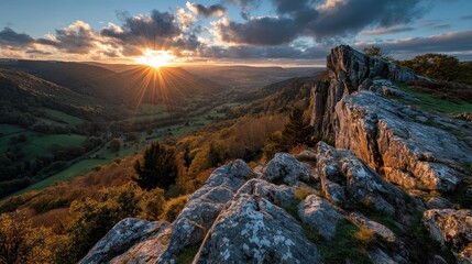 Sunset over valley seen from rocky peak dramatic light nature landscape